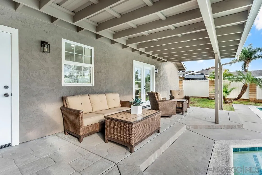 9209 Arnaz Way Santee, CA 92071 - Photo 29 of 39 a living room with furniture and a floor to ceiling window