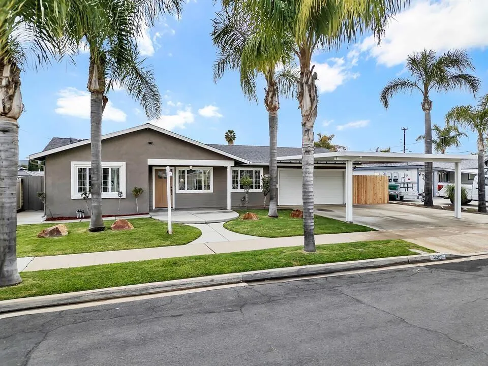 9209 Arnaz Way Santee, CA 92071 - Photo 3 of 39 a front view of a house with a garden and trees