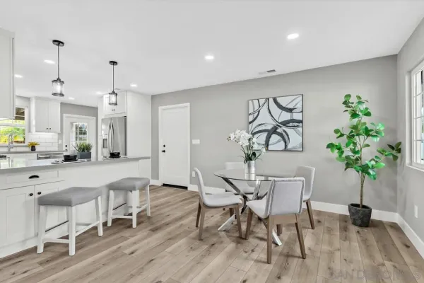 a view of a dining room with furniture and chandelier