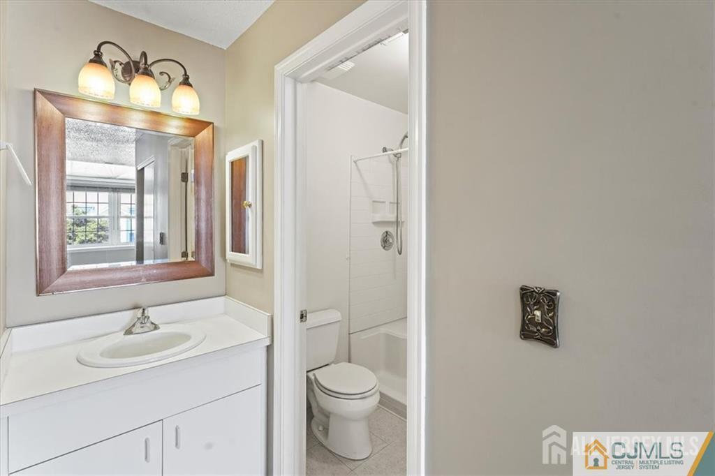 834 Edpas Road New Brunswick, NJ 08901 - Photo 2 of 20 a bathroom with a toilet sink a mirror and shower
