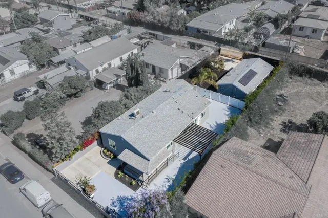 an aerial view of a house with a yard