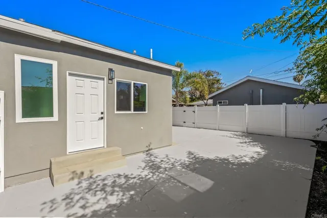 a big house with palm trees in front of it