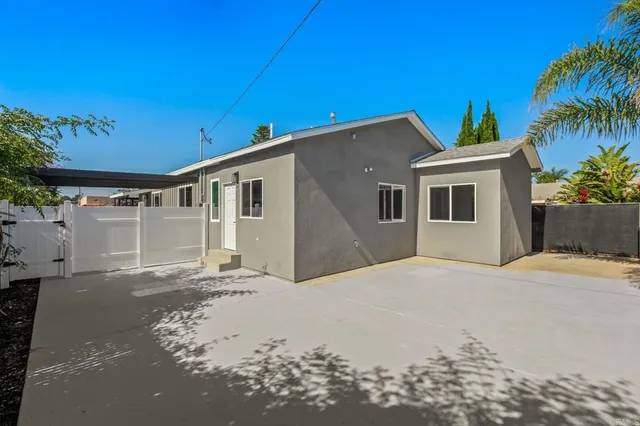 a kitchen with granite countertop a refrigerator and a stove top oven