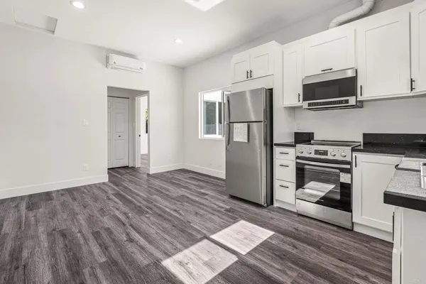 a kitchen with stainless steel appliances granite countertop a stove and a refrigerator