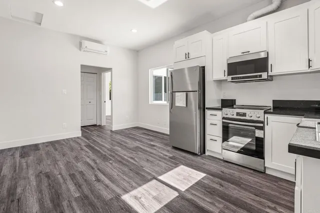 a kitchen with stainless steel appliances granite countertop a stove and a refrigerator