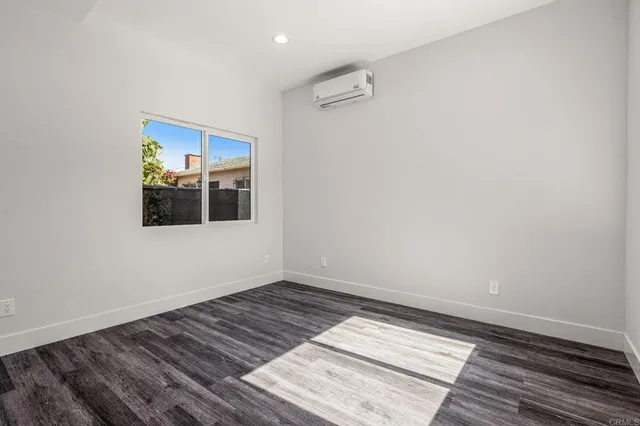a bathroom with a granite countertop sink a toilet and a mirror