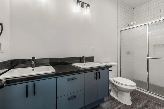 a bathroom with a toilet and a shower