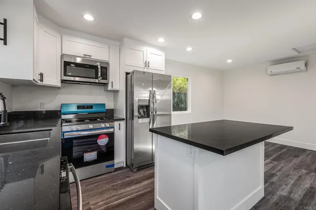 a view of bathroom with a sink and mirror
