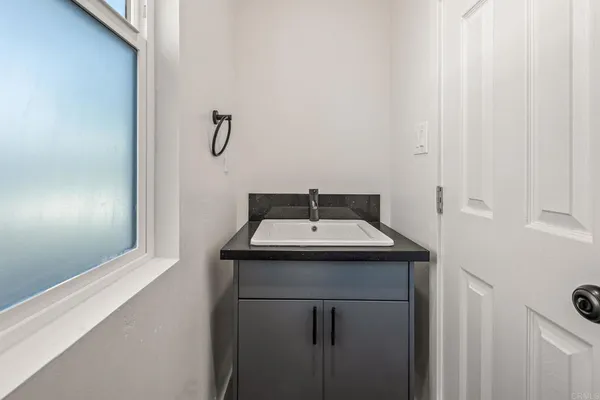 an empty room with wooden floor and a window