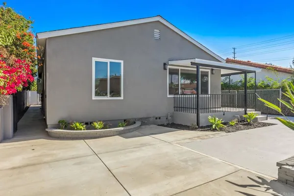 a front view of a house with a garden
