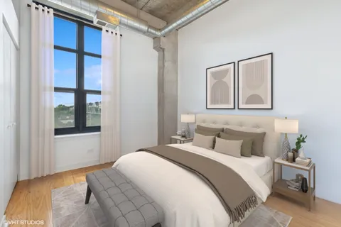 a bedroom with a bed and a refrigerator