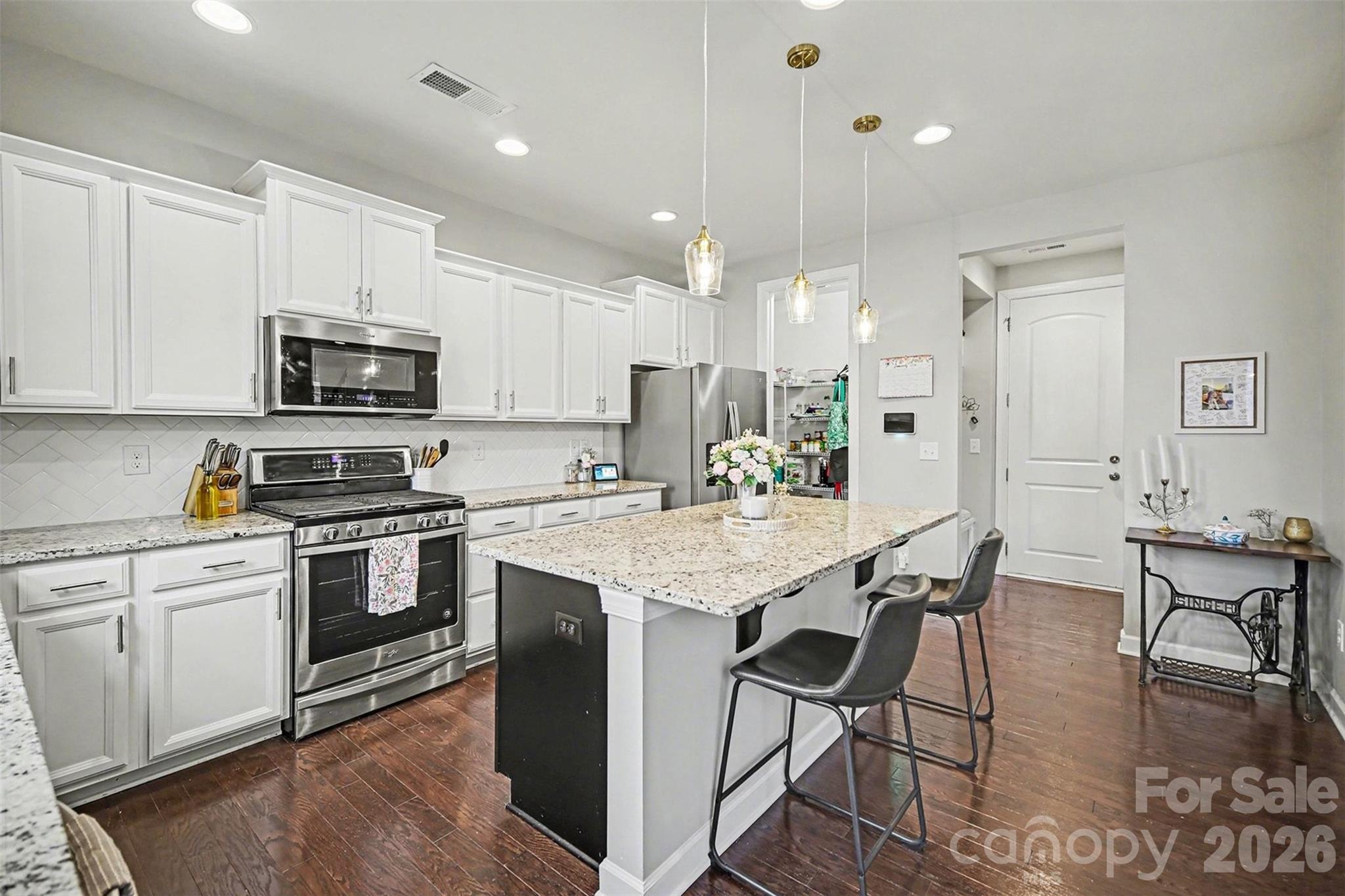 18314 McKee Road Charlotte, NC 28278 - Photo 16 of 37 a kitchen with granite countertop white cabinets and stainless steel appliances