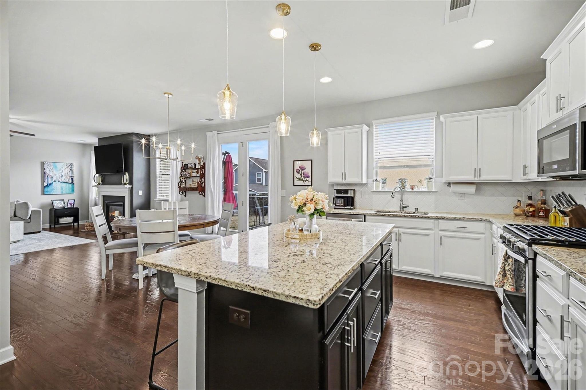18314 McKee Road Charlotte, NC 28278 - Photo 17 of 37 a kitchen with granite countertop a stove top oven a sink a counter top space and cabinets