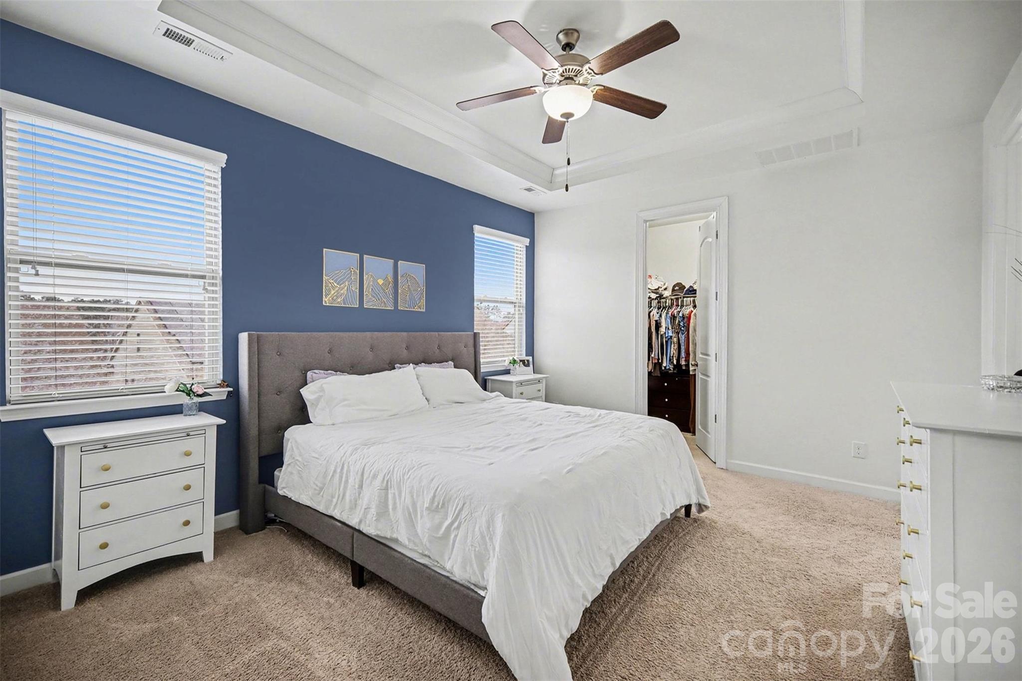 18314 McKee Road Charlotte, NC 28278 - Photo 23 of 37 a bedroom with a large bed and a chandelier