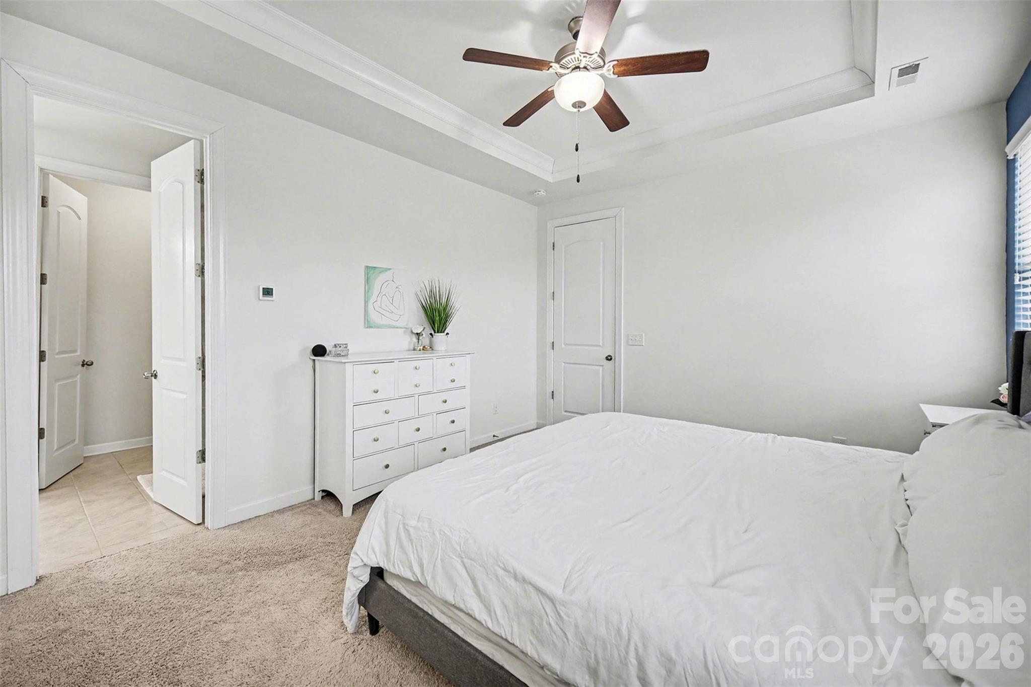 18314 McKee Road Charlotte, NC 28278 - Photo 24 of 37 a bedroom with a bed and a chandelier