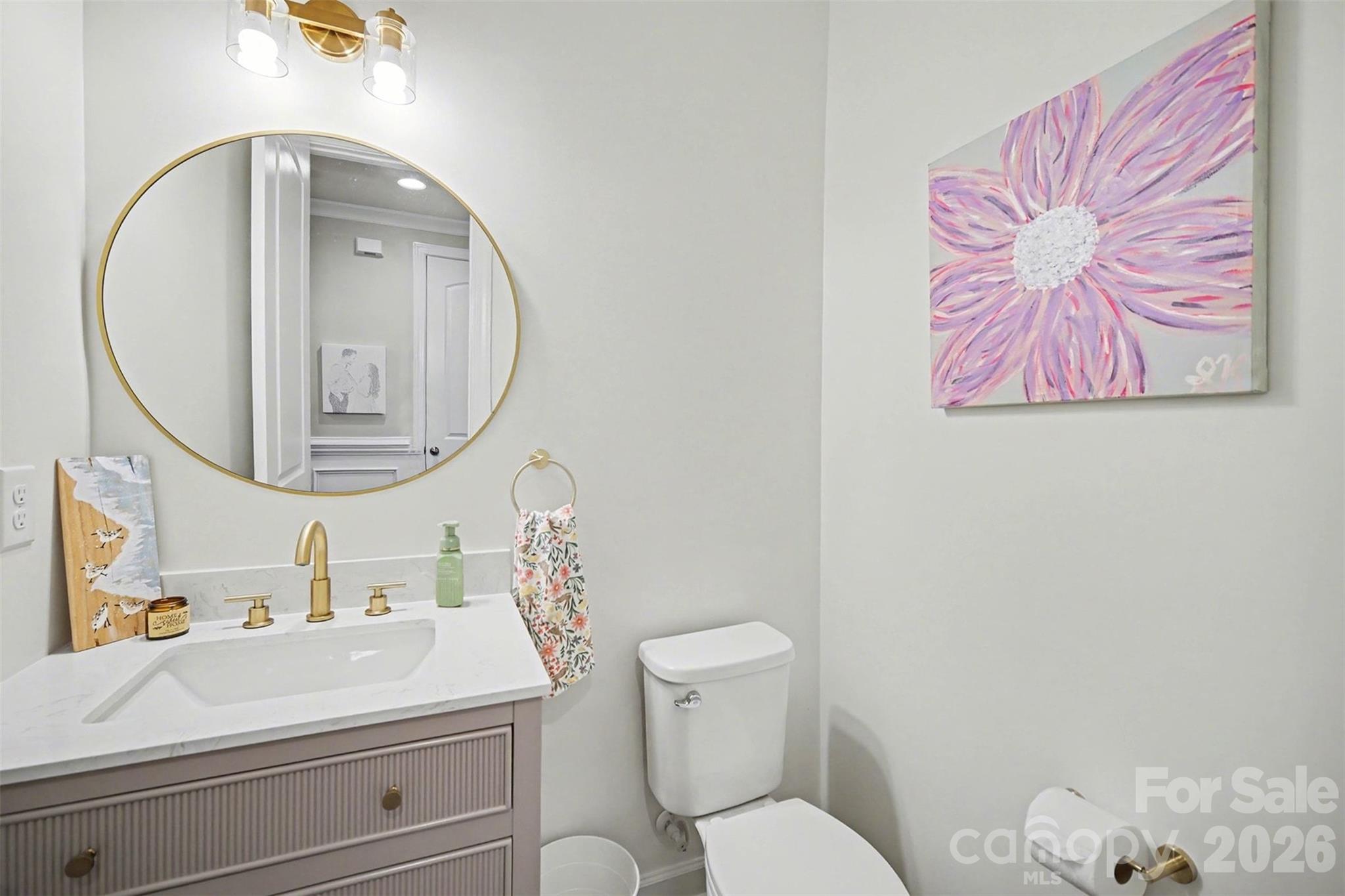 18314 McKee Road Charlotte, NC 28278 - Photo 7 of 37 a bathroom with a toilet sink vanity and mirror