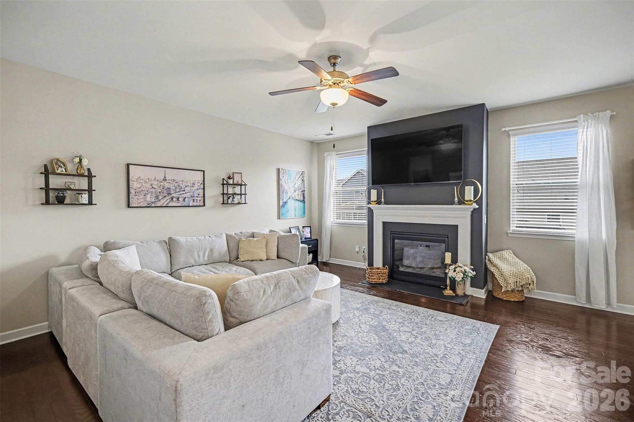 18314 McKee Road Charlotte, NC 28278 - Photo 9 of 37 a living room with furniture a flat screen tv and a fireplace
