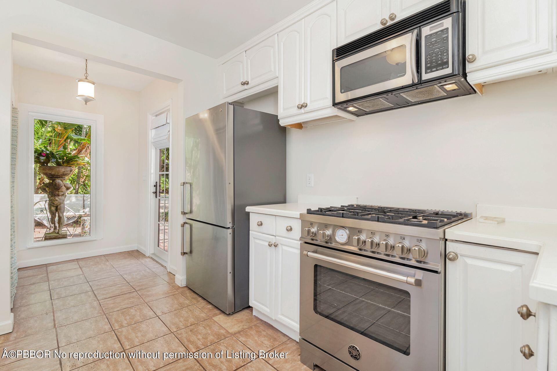 827 Ardmore Road West Palm Beach, FL 33401 - Photo 12 of 27 a kitchen with a stove top oven and refrigerator