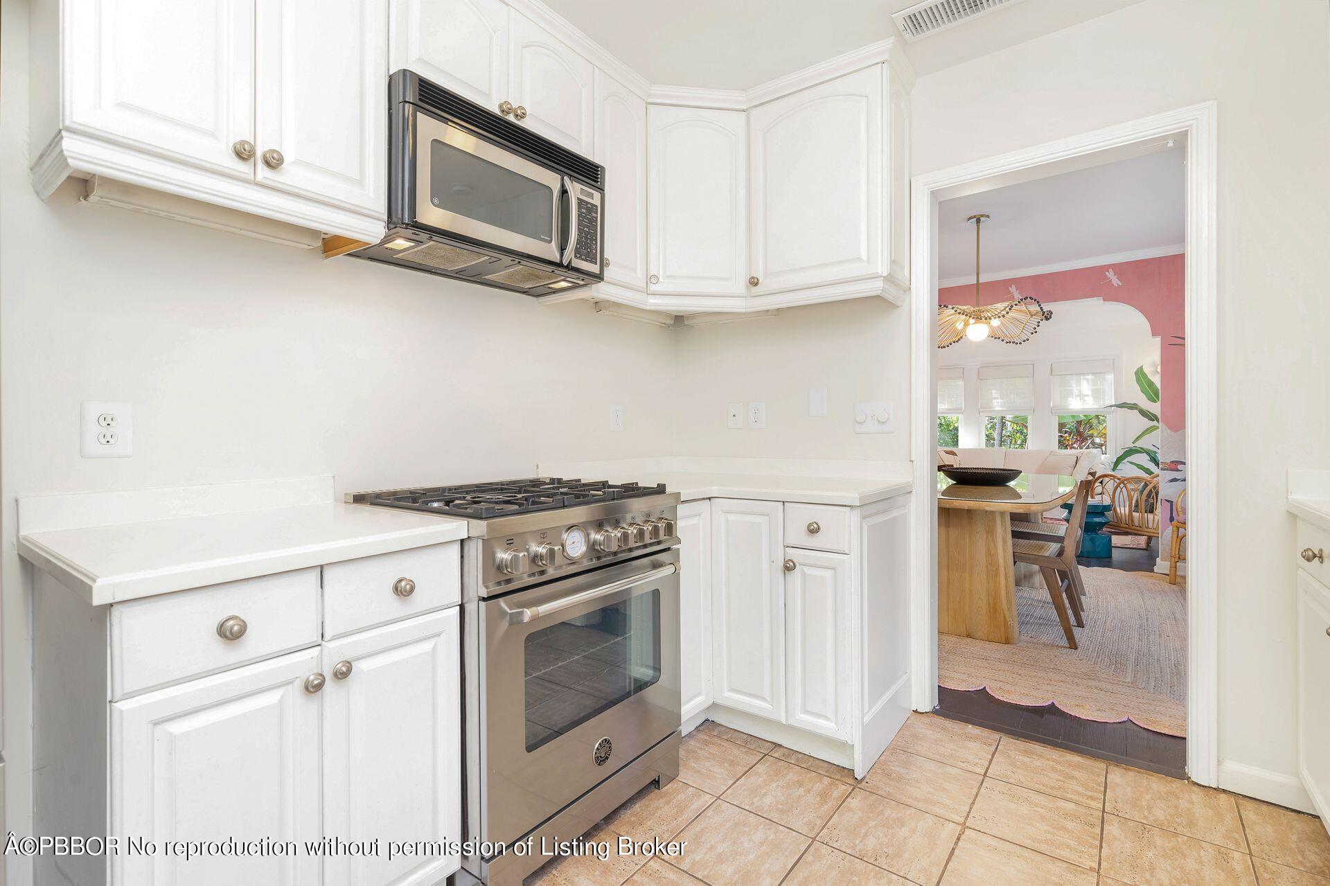 827 Ardmore Road West Palm Beach, FL 33401 - Photo 13 of 27 a kitchen with stainless steel appliances white cabinets and a stove top oven
