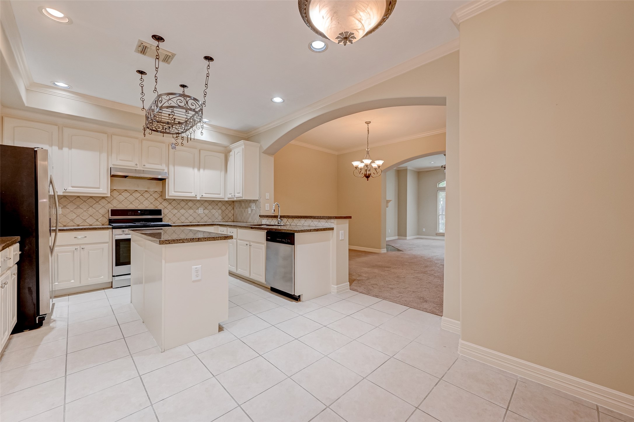 13607 Brookbluff Lane Houston, TX 77077 - Photo 17 of 50 a kitchen with white cabinets and stainless steel appliances
