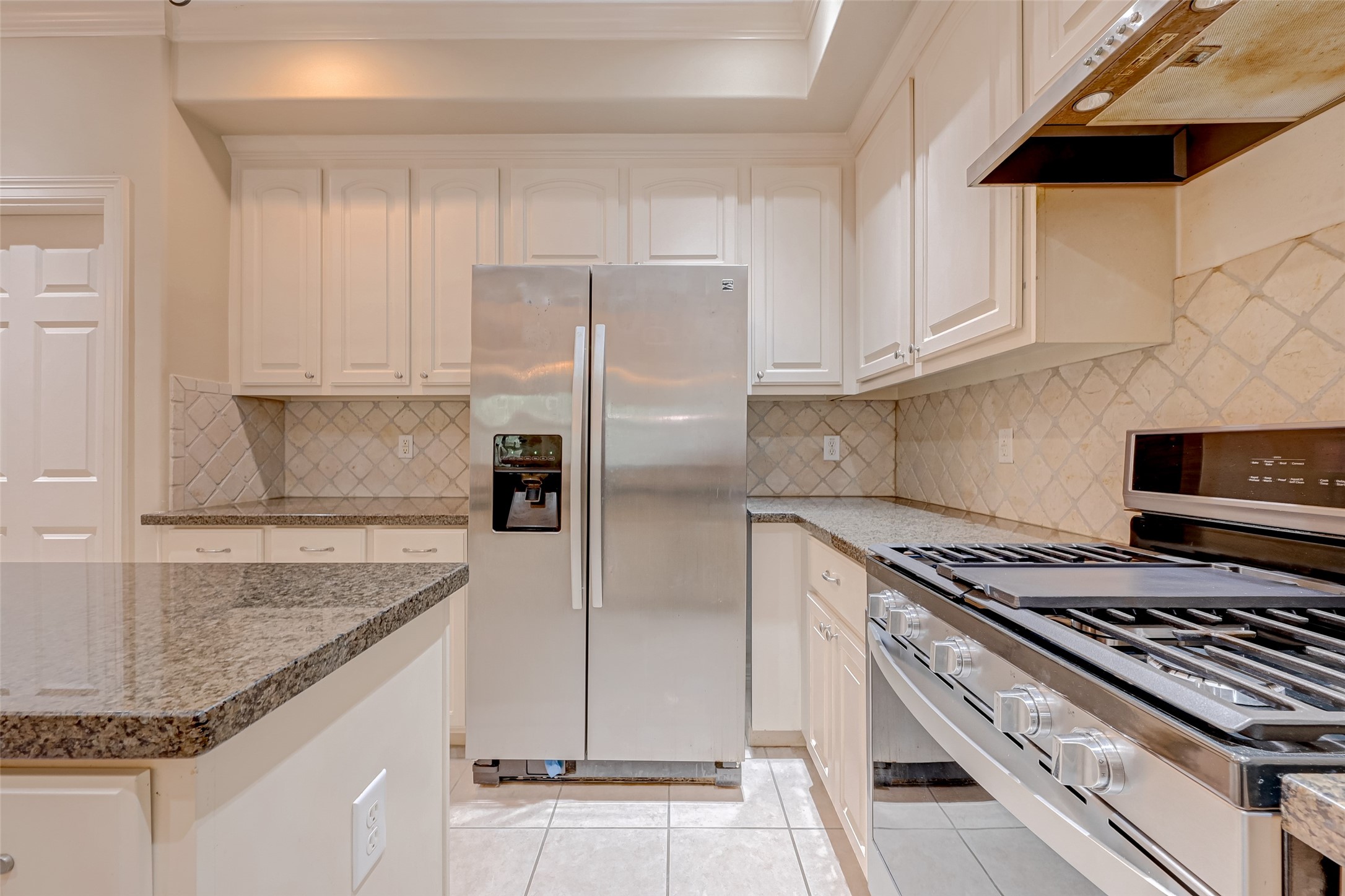 13607 Brookbluff Lane Houston, TX 77077 - Photo 24 of 50 a kitchen with stainless steel appliances granite countertop a sink stove and refrigerator