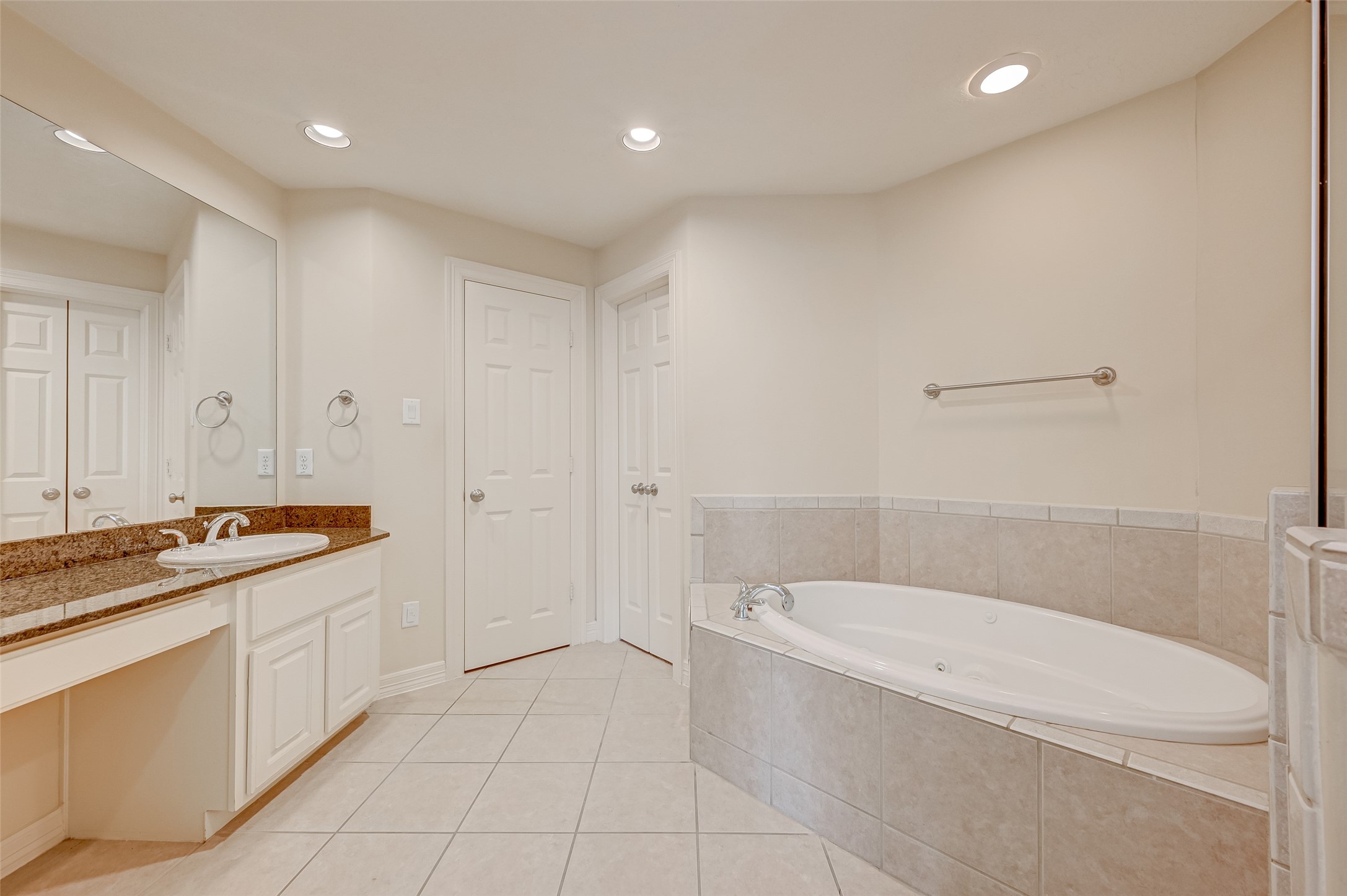 13607 Brookbluff Lane Houston, TX 77077 - Photo 40 of 50 a bathroom with a granite countertop sink a toilet and bathtub