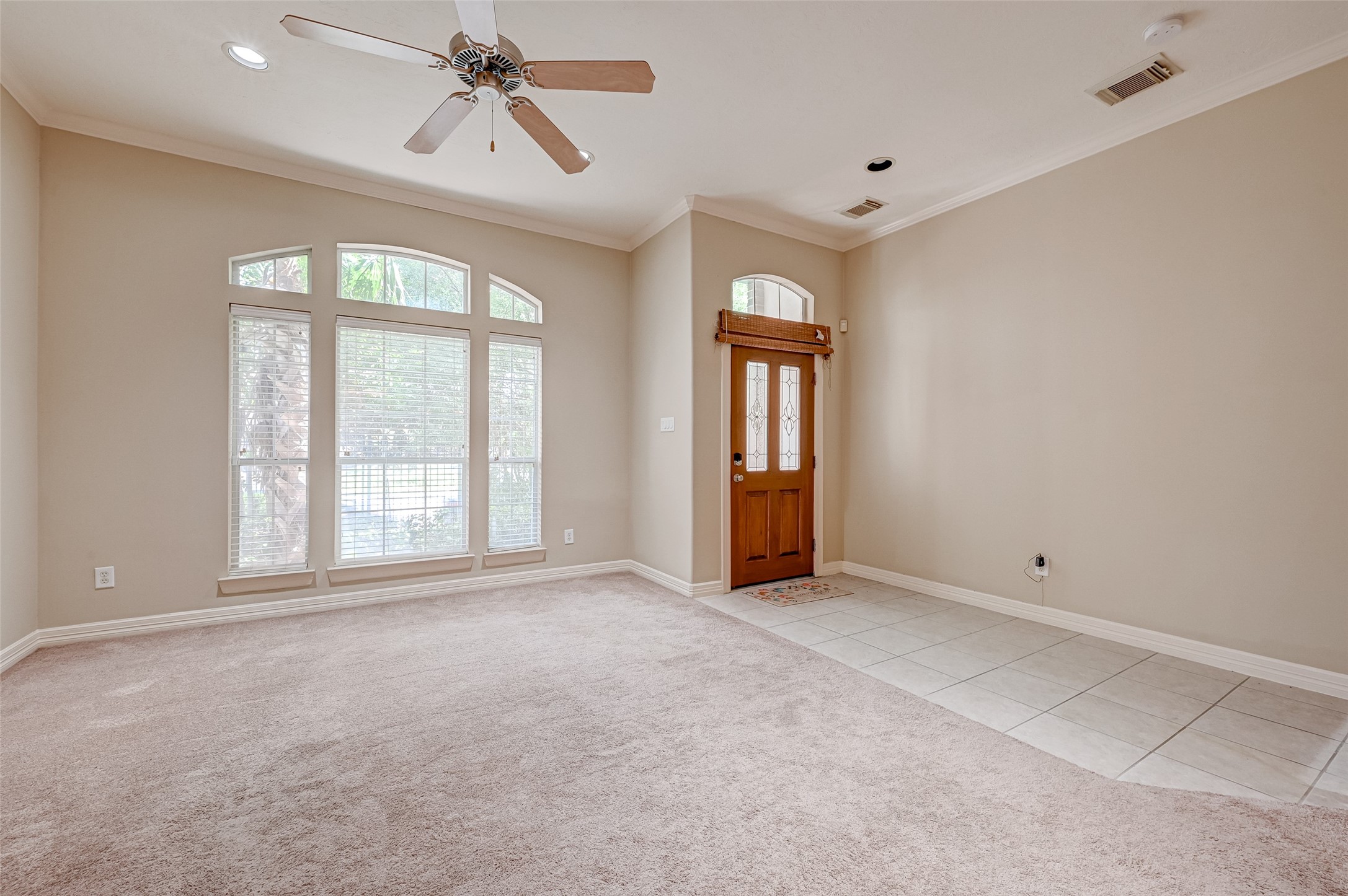13607 Brookbluff Lane Houston, TX 77077 - Photo 9 of 50 an empty room with chandelier fan and windows