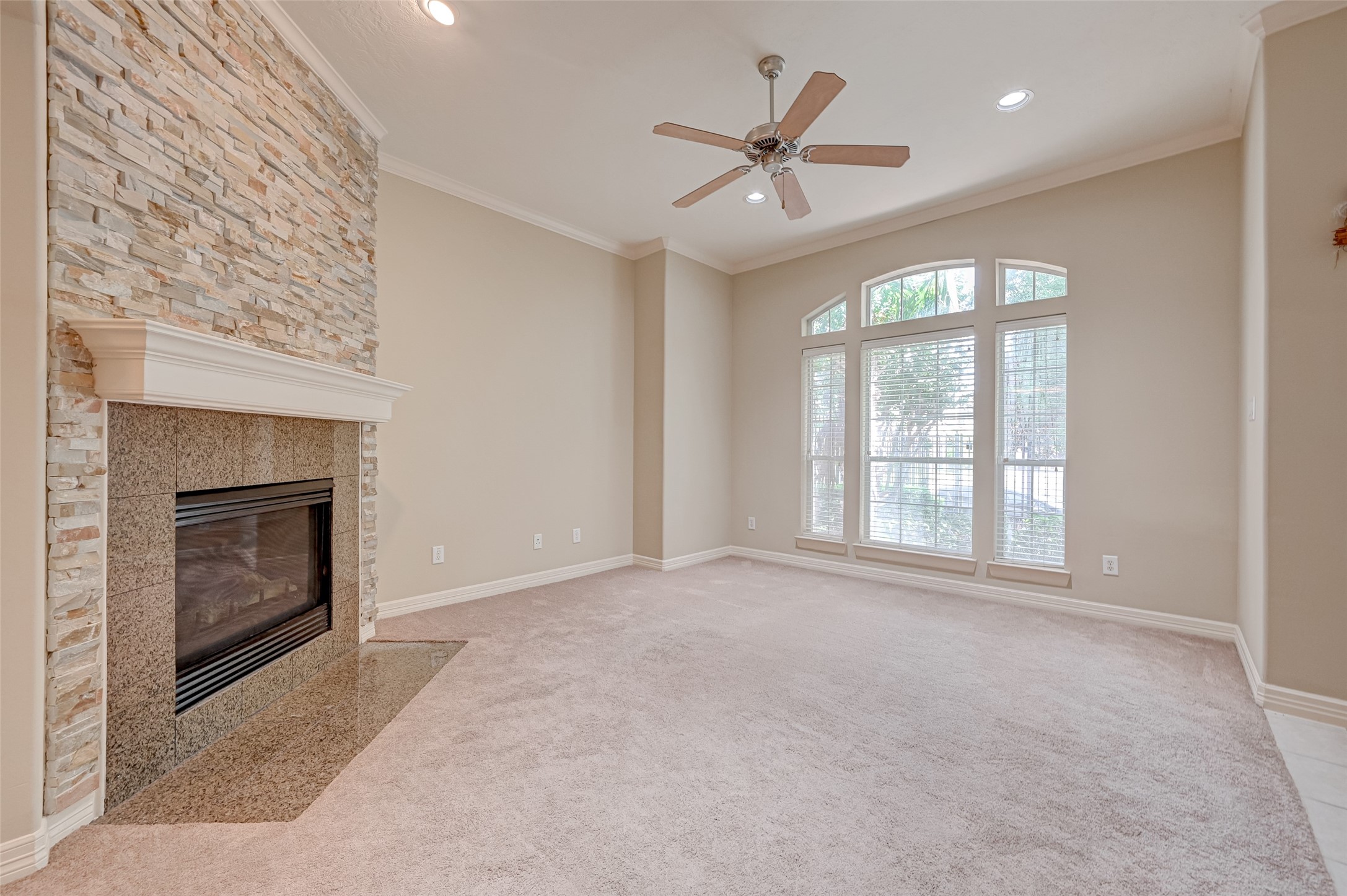 13607 Brookbluff Lane Houston, TX 77077 - Photo 10 of 50 an empty room with windows and fireplace