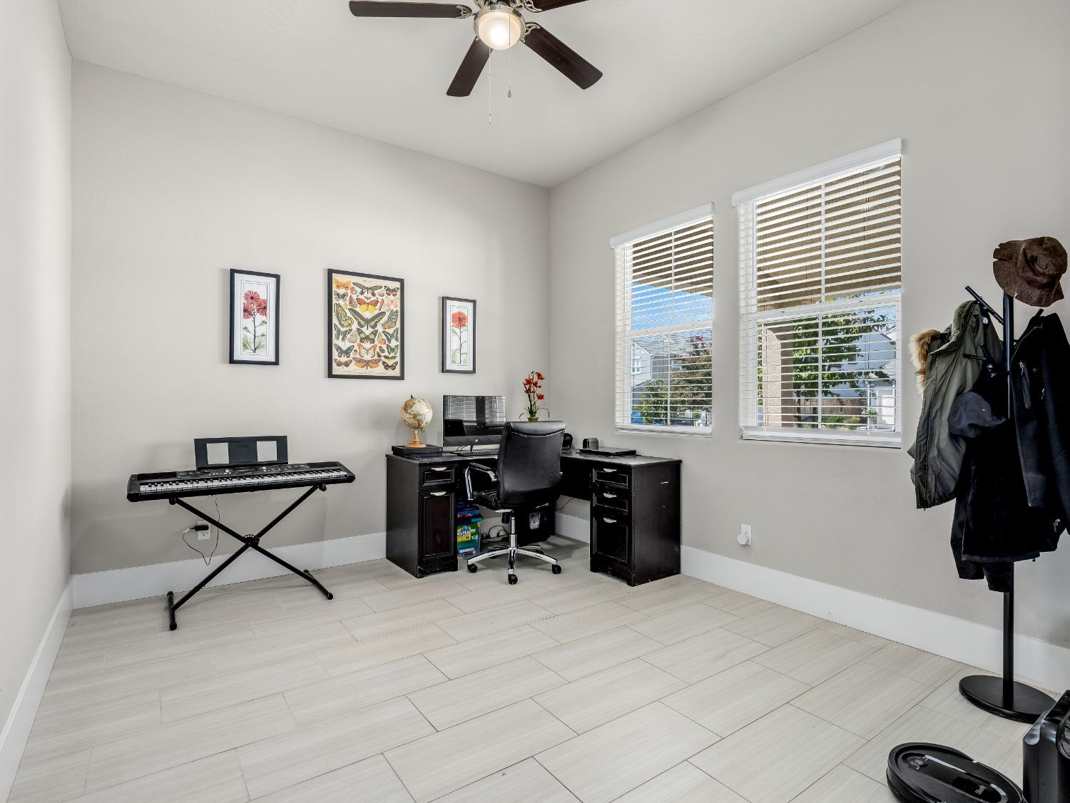4289 Vineyard Drive Madera, CA 93636 - Photo 11 of 37 a view of a workspace with furniture and a window