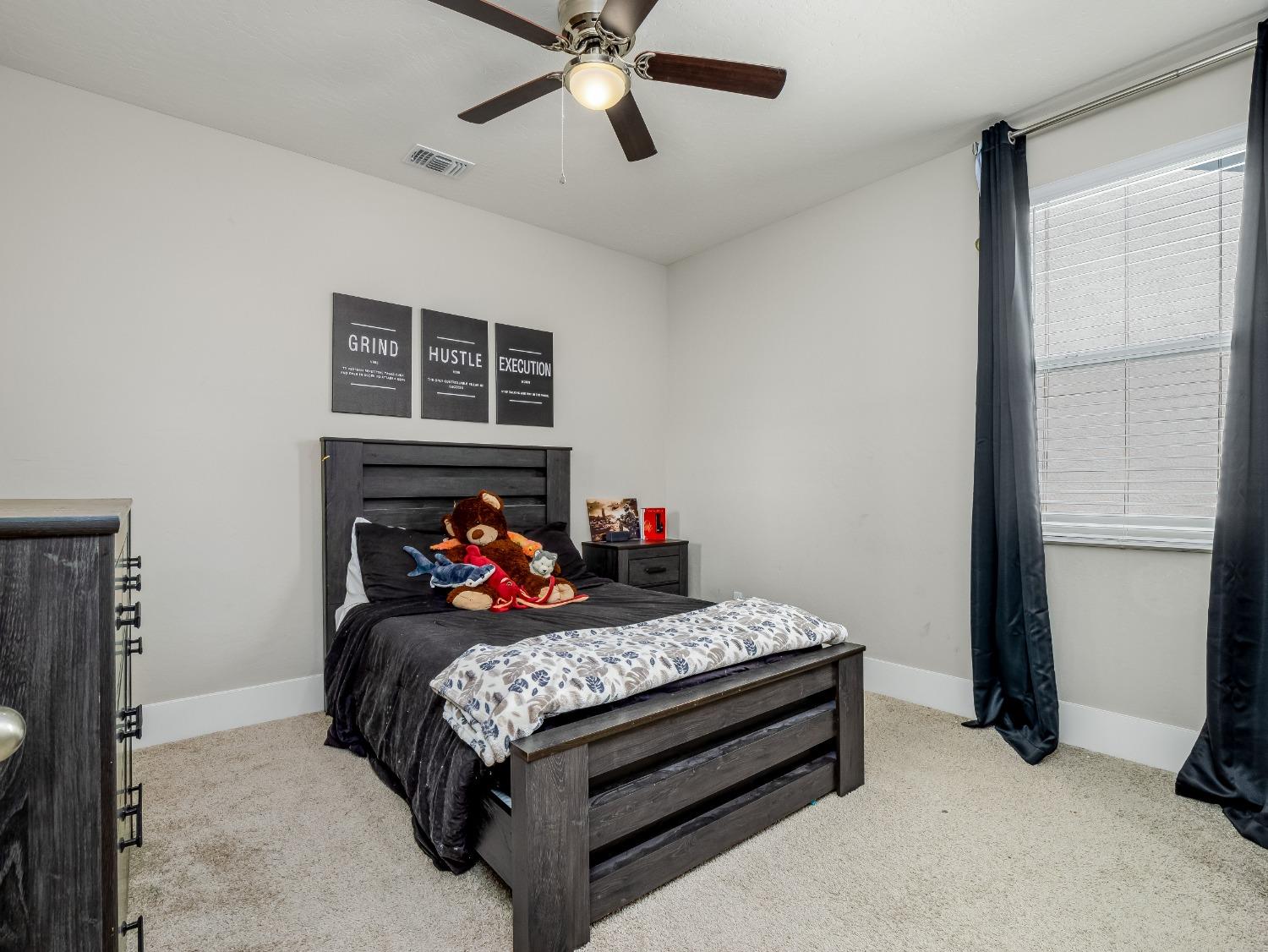 4289 Vineyard Drive Madera, CA 93636 - Photo 23 of 37 a bedroom with a bed and a window