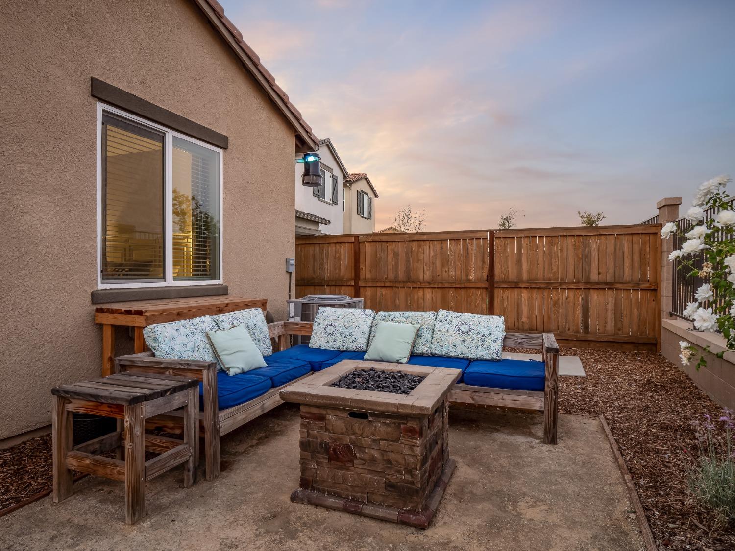 4289 Vineyard Drive Madera, CA 93636 - Photo 32 of 37 a blue bench sitting in backside of a house
