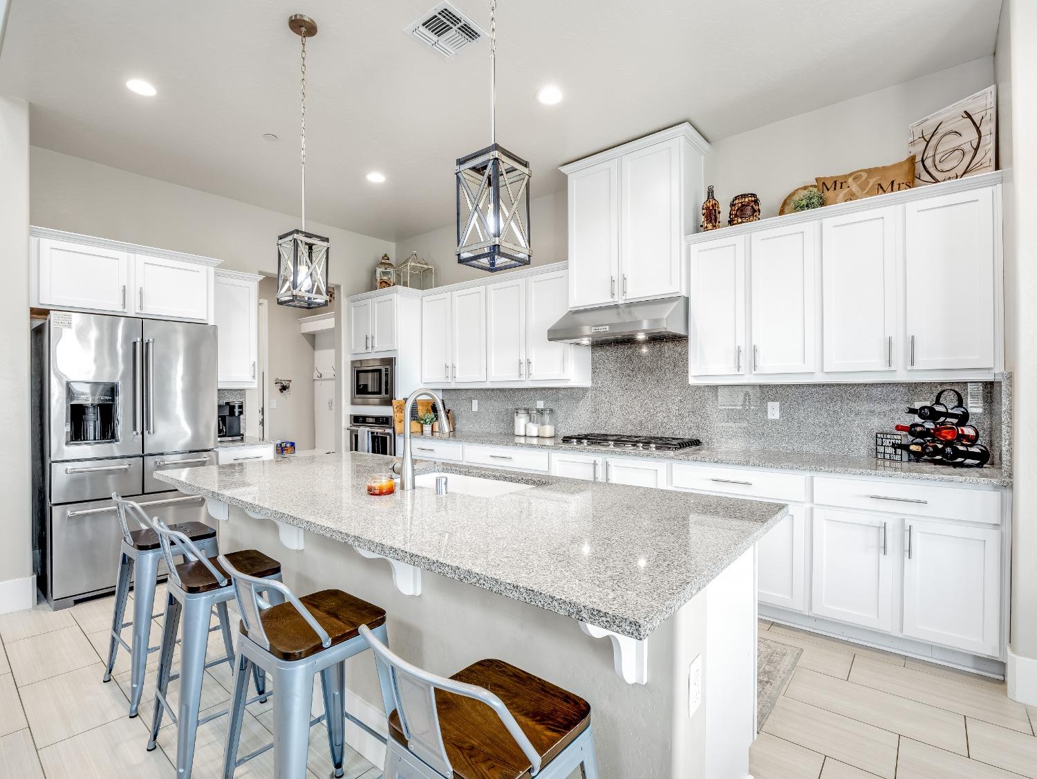 4289 Vineyard Drive Madera, CA 93636 - Photo 6 of 37 a large kitchen with lots of counter space and appliances