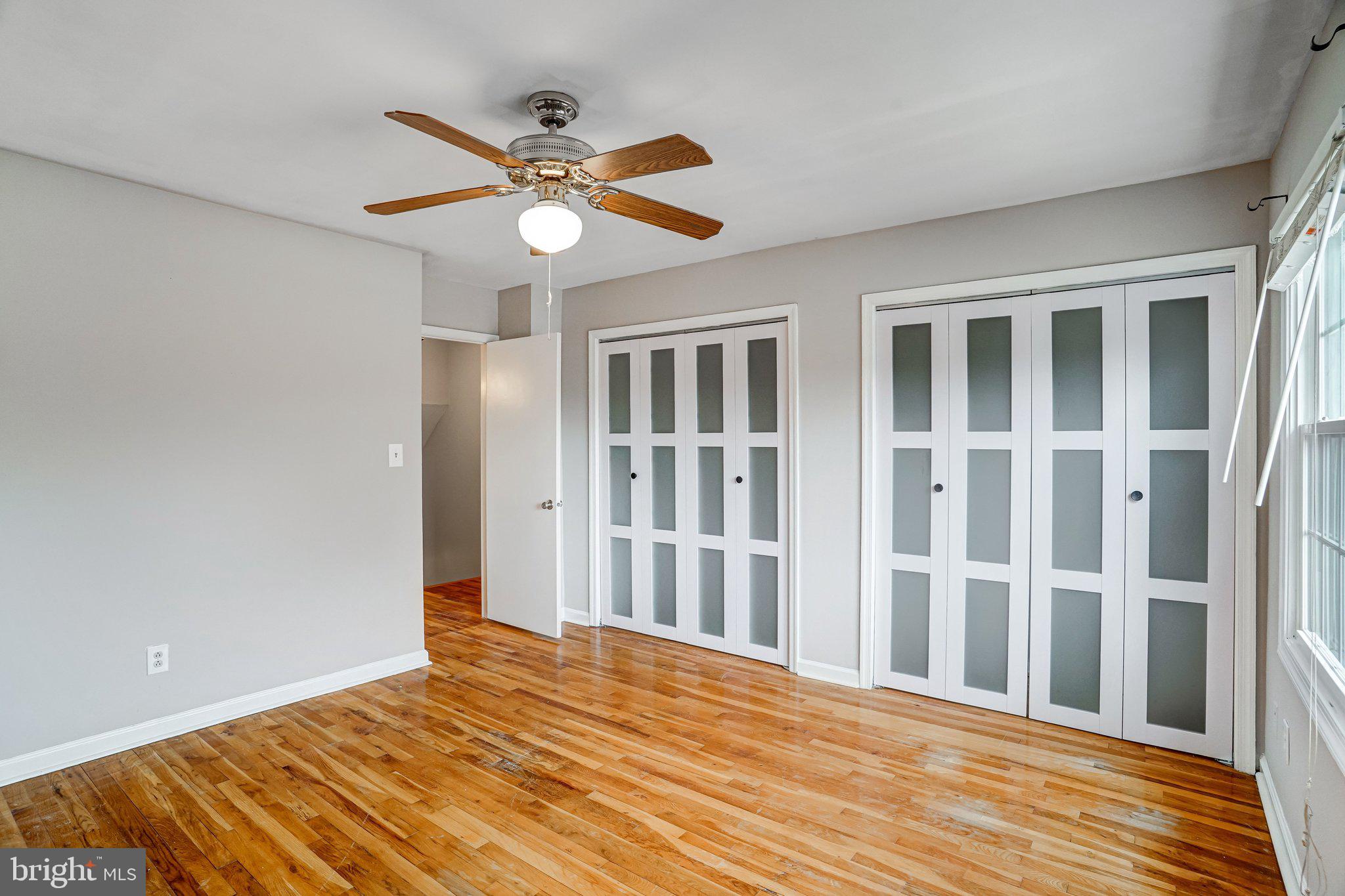 8396 Forrester Boulevard, Unit 555 Springfield, VA 22152 - Photo 14 of 24 a view of a livingroom with a ceiling fan and wooden floor