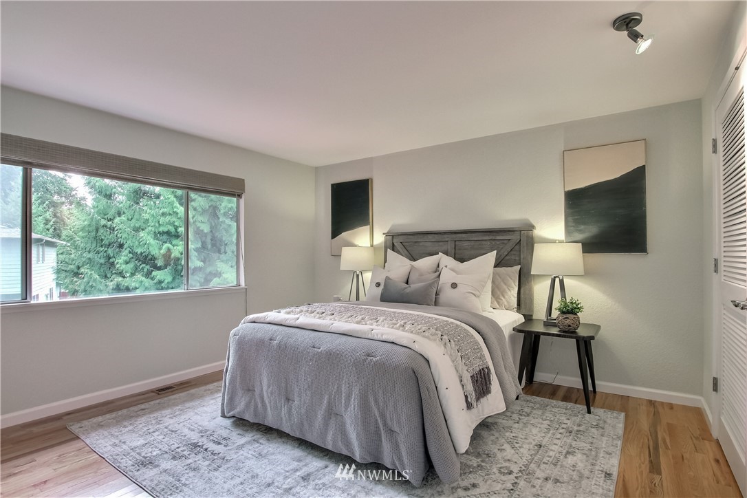 2327 168th Street Southeast Bothell, WA 98012 - Photo 14 of 25 a bedroom with a bed and a flat tv screen on dresser