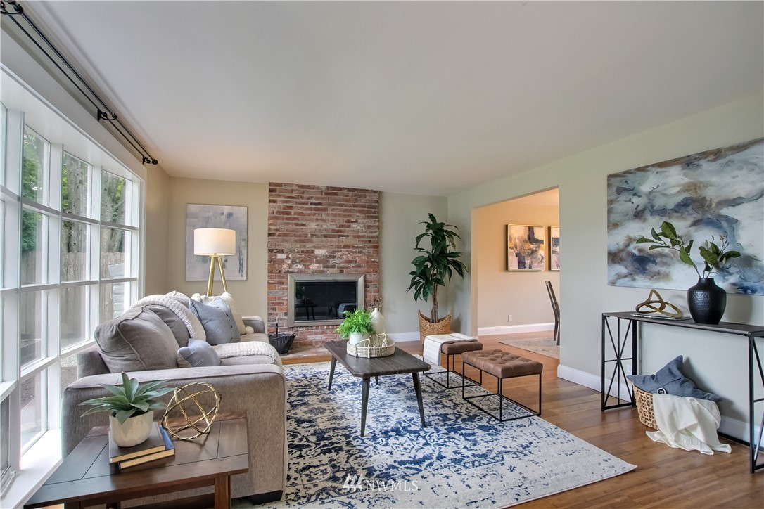 2327 168th Street Southeast Bothell, WA 98012 - Photo 5 of 25 a living room with furniture a fireplace and a table