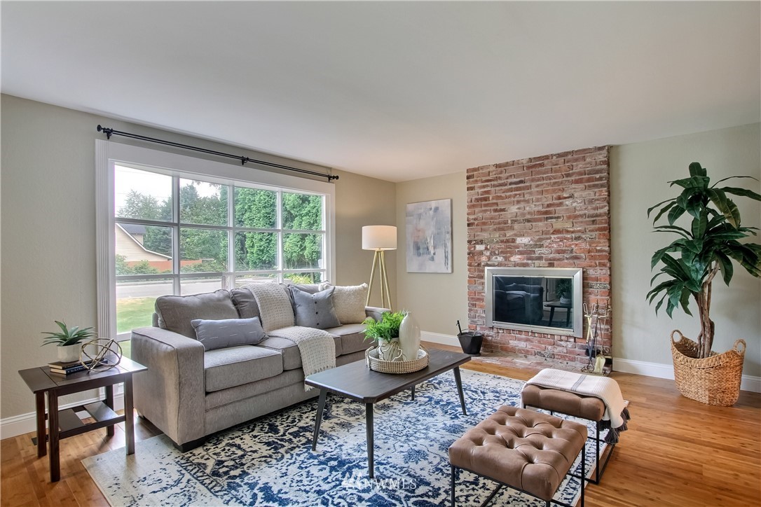 2327 168th Street Southeast Bothell, WA 98012 - Photo 6 of 25 a living room with furniture potted plant and a fireplace