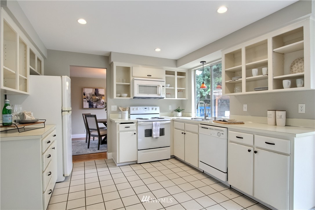 2327 168th Street Southeast Bothell, WA 98012 - Photo 9 of 25 a kitchen with white cabinets and appliances