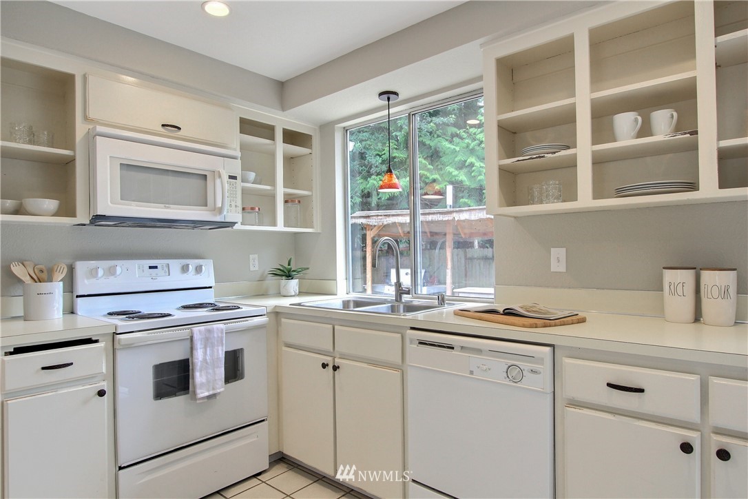 2327 168th Street Southeast Bothell, WA 98012 - Photo 10 of 25 a kitchen with cabinets appliances a sink and a window