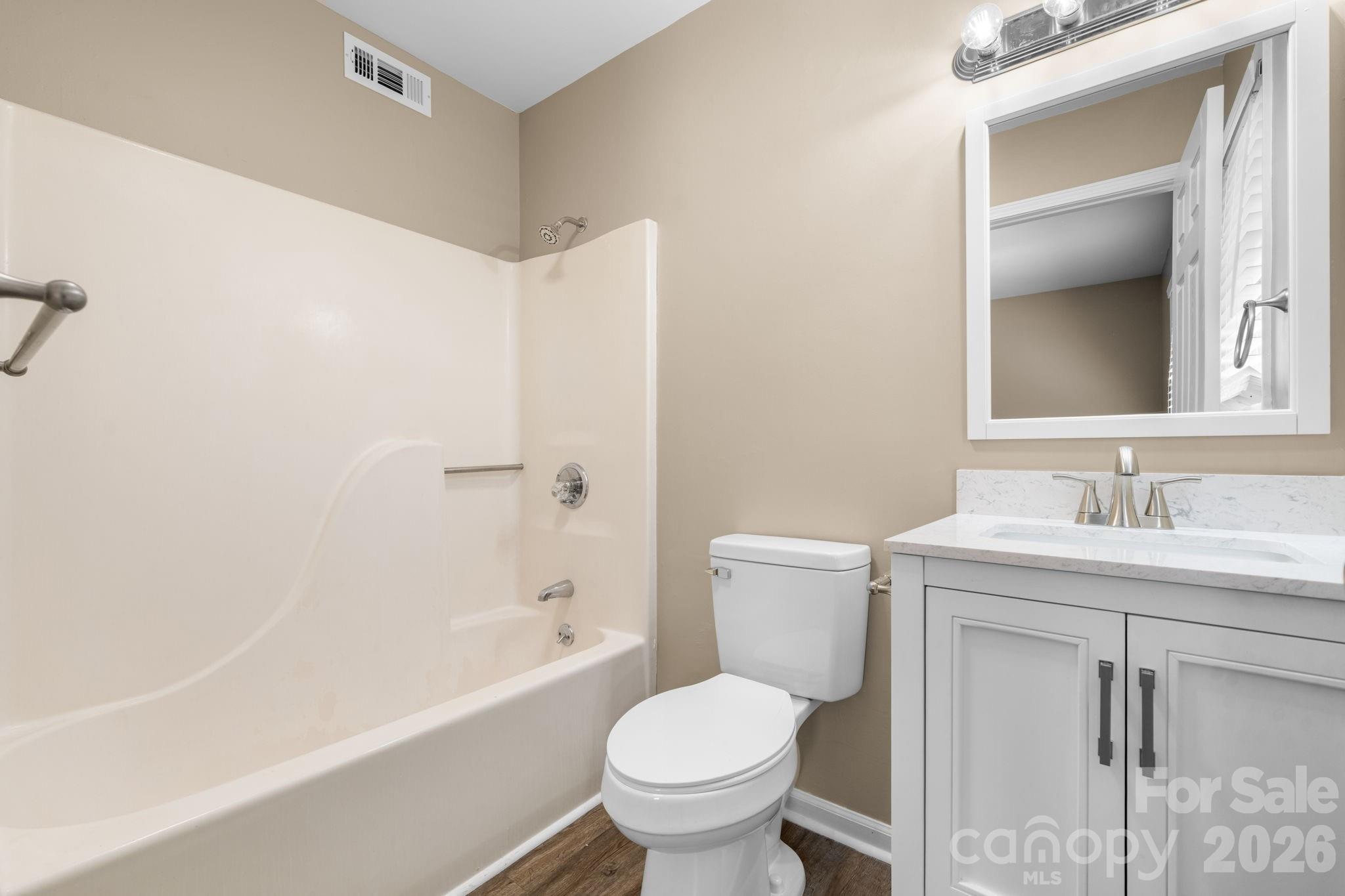 525 12th Street Southwest, Unit 30 Hickory, NC 28602 - Photo 13 of 22 a bathroom with a granite countertop toilet a sink and a bathtub