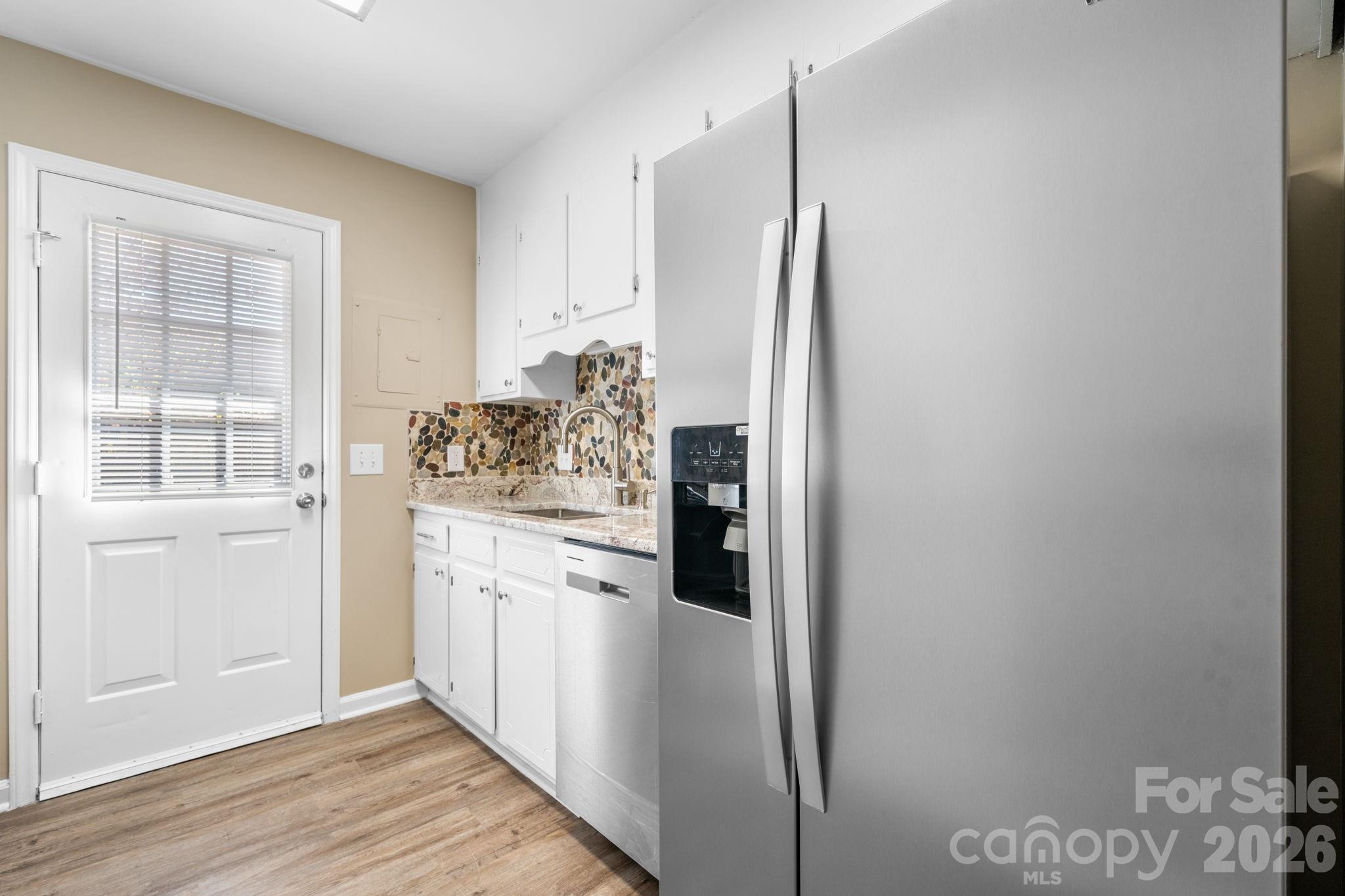 525 12th Street Southwest, Unit 30 Hickory, NC 28602 - Photo 5 of 22 a kitchen with stainless steel appliances a refrigerator and a stove