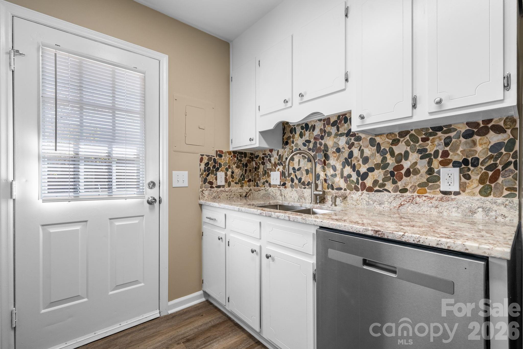 525 12th Street Southwest, Unit 30 Hickory, NC 28602 - Photo 6 of 22 a kitchen with granite countertop white cabinets and white appliances