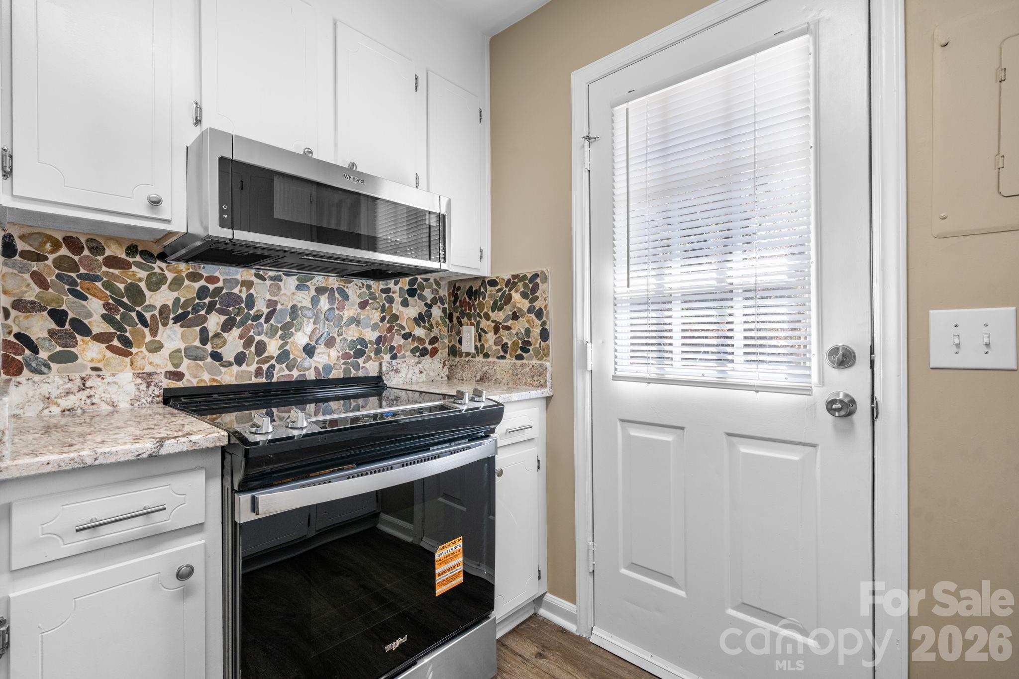 525 12th Street Southwest, Unit 30 Hickory, NC 28602 - Photo 8 of 22 a kitchen with granite countertop cabinets stainless steel appliances and a window
