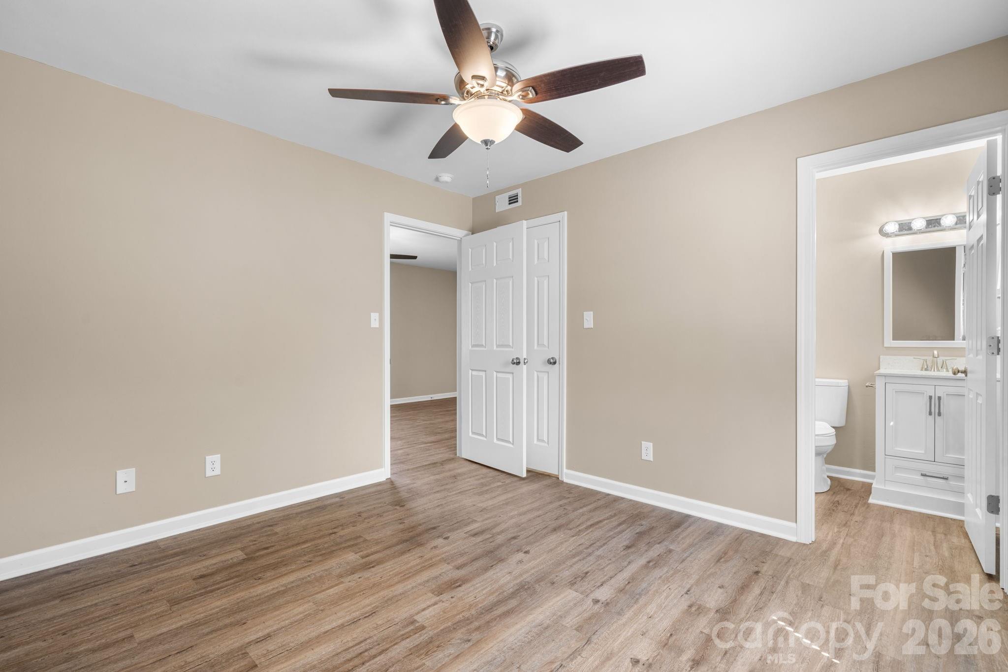 525 12th Street Southwest, Unit 30 Hickory, NC 28602 - Photo 10 of 22 an empty room with wooden floor and a ceiling fan