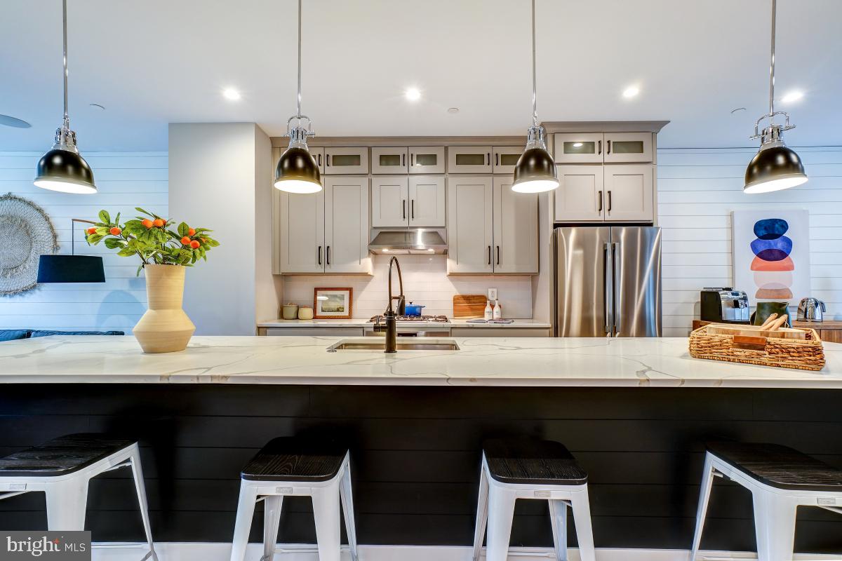 a kitchen with kitchen island granite countertop a sink cabinets and window