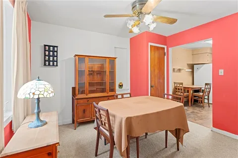 a view of a dining room with furniture and chandelier
