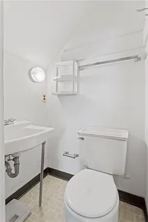 a white toilet sitting next to a bathroom sink