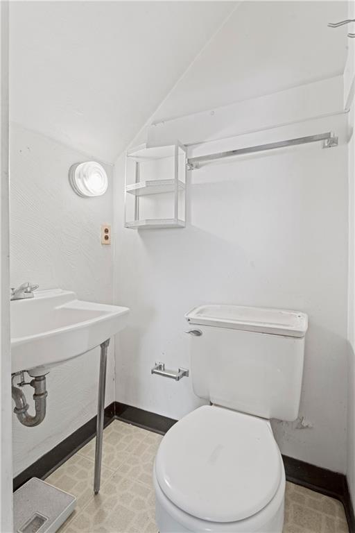 720 6th Street Verona, PA 15147 - Photo 23 of 28 a white toilet sitting next to a bathroom sink