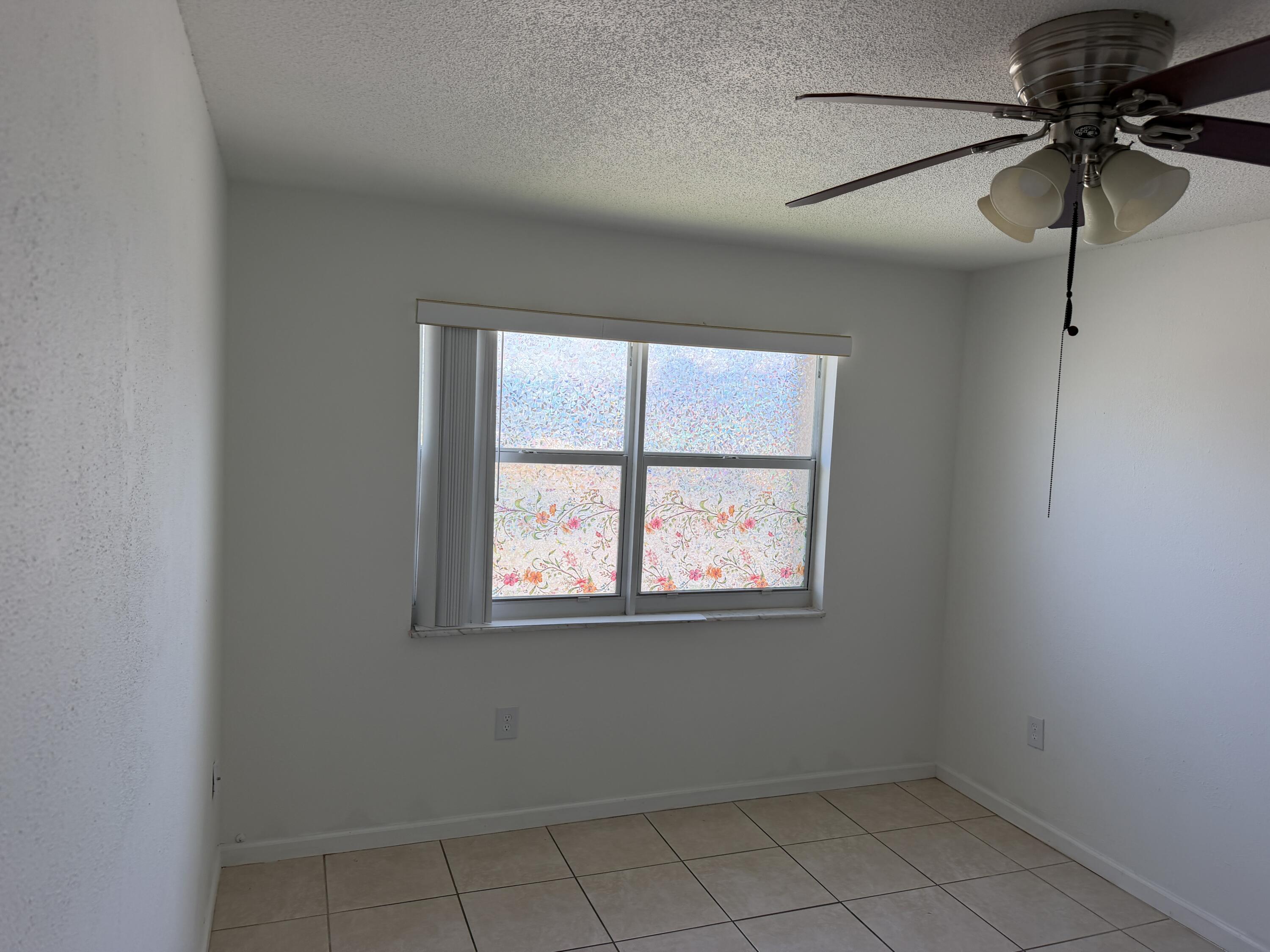 506 Davis Road, Unit 70 Palm Springs, FL 33461 - Photo 23 of 25 an empty room with a window
