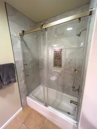 a bathroom with a glass shower door