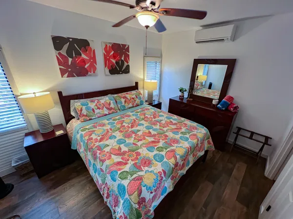 a bedroom with a bed and wooden floor